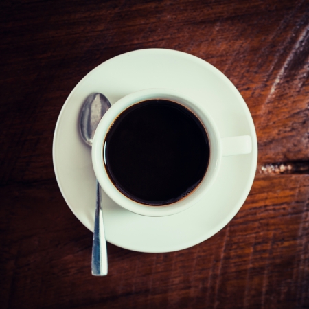 Black coffee in white cup on woodenの写真素材