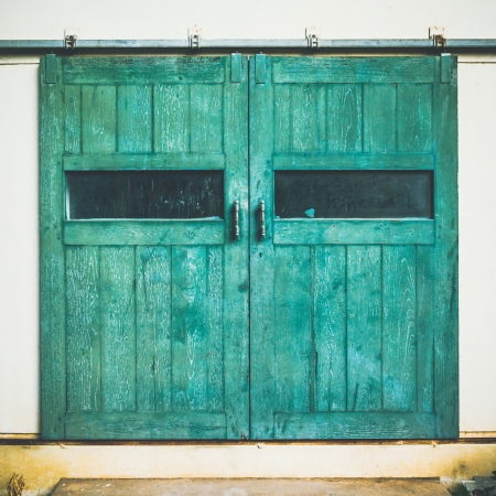 Vintage door on green cement wallの写真素材