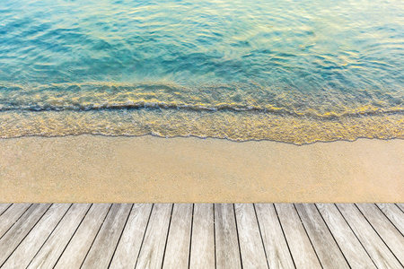 wood bridge and wave of the sea on sand beachの写真素材