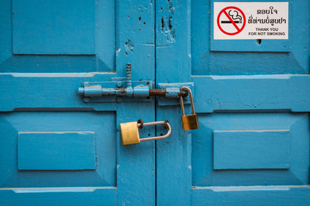 Blue door double lock with no smoking sign in laosの写真素材