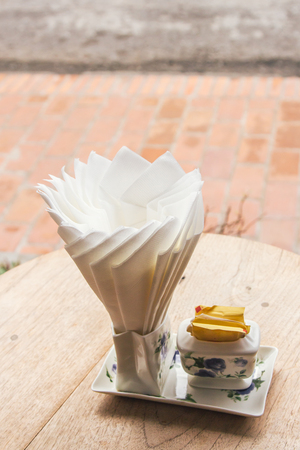 Tissue paper on wood table in coffee shopの写真素材