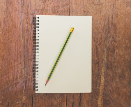 book and pencil on wood table