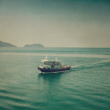 Fishing boat on blue sea vintage.の写真素材