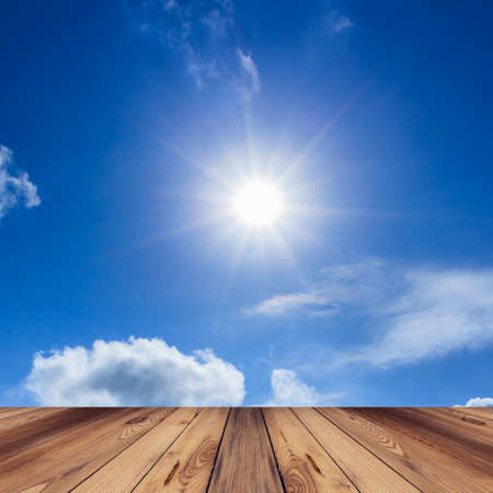 Wood floor, Blue sky with cloud and sunの写真素材