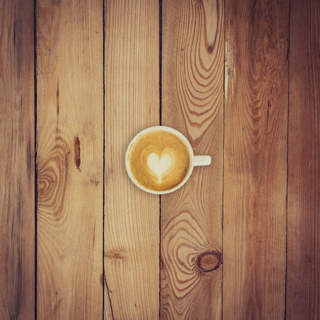 Latte coffee on wood background and textureの写真素材