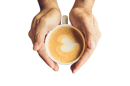 Man holding hot cup of coffee and heart shape with clipping path.の写真素材