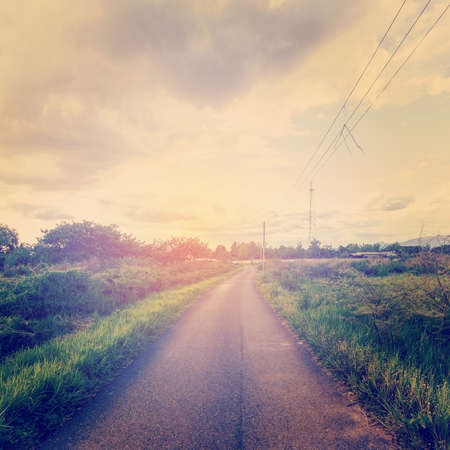 Vintage photo of field and road with sunlightの写真素材