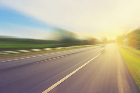 Empty asphalt road in motion blur and sunlight with vintage tone.の写真素材