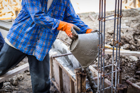 worker mixing cement mortar plaster for constructionの写真素材