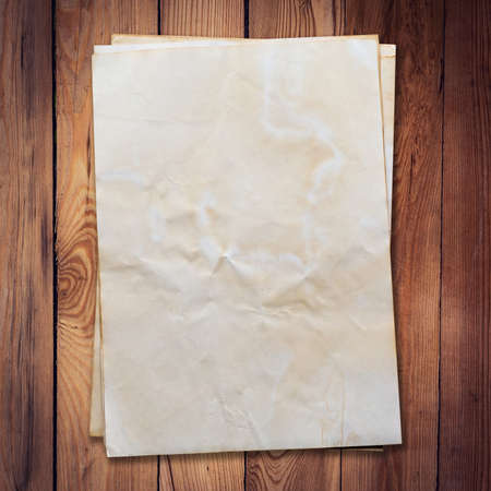 old paper on wood background and texture with space.の写真素材