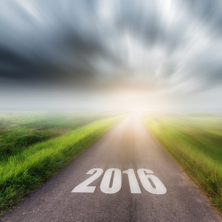 Country road on field and storm clouds or rainclouds. Forward to the New Year 2016