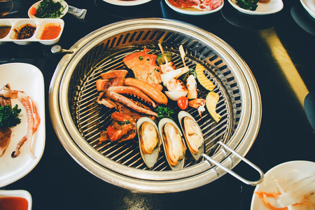 Food on Korean BBQ grill, meat and vegetableの写真素材