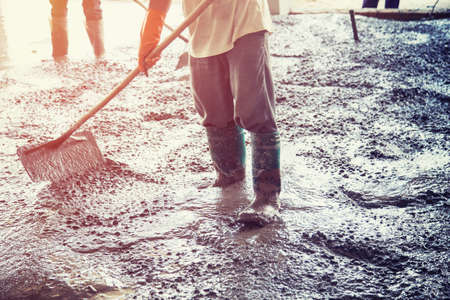Plasterer screed concrete for floor in buildingの写真素材