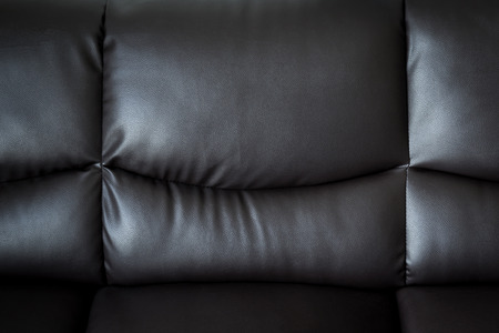 close up black leather sofa and textured and background with space.の写真素材