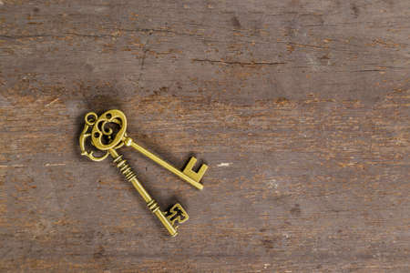 old key on wood background with spaceの写真素材