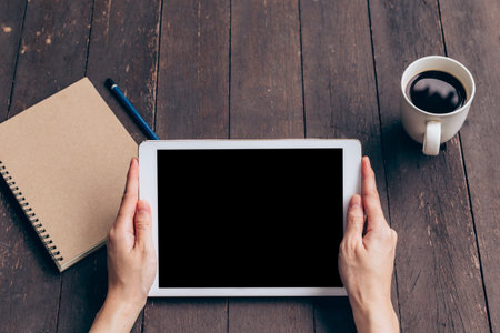Asian woman using tablet on table in coffee shop with vintage toned.の写真素材
