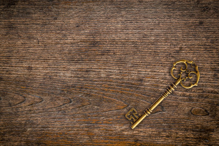 Vintage key on wood texture and background with space.の写真素材
