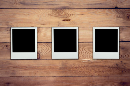 Blank photo frame on wood background and textureの写真素材