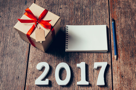 Wooden numbers forming the number 2017, For the new year 2017 on rustic wooden with gift box and red...