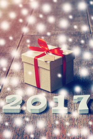 Wooden numbers forming the number 2017, For the new year and snow on rustic wooden with gift box and...