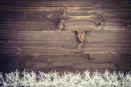 Wooden brown christmas background and white snowflakes with space.の写真素材