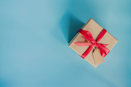 top view brown gift box for new year on blue pastel color background with space.