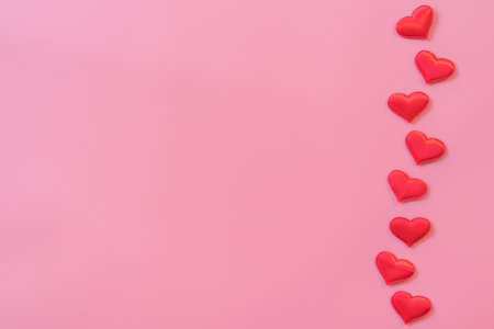 Red heart on pink pastel color background with space for text.