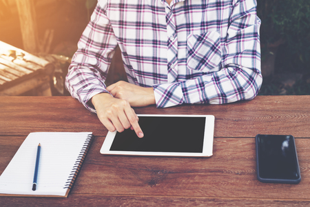Asia woman using tablet on table in coffee shop. vintage toned.の写真素材