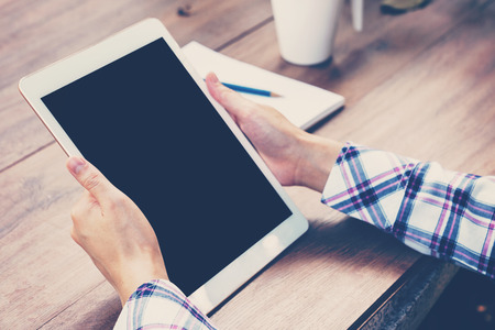 Asia woman using tablet on table in coffee shop. vintage toned.の写真素材