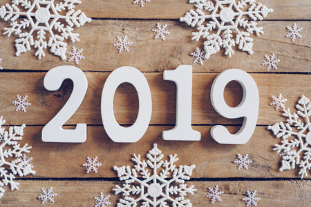 New Year 2019 on wooden brown christmas background with snowflakes and christmas decoration.の写真素材