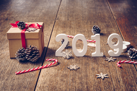 Top view wooden numbers forming the number 2019, For the new year 2019 on rustic wooden with gift box and red ribbon and christmas decoration.の写真素材