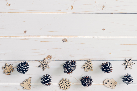 Wooden white and christmas background with snowflakes, pine cones and christmas decoration.の写真素材