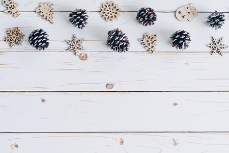 Wooden white and christmas background with snowflakes, pine cones and christmas decoration.の写真素材