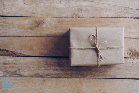 Above brown gift box on wooden table background with copy space.の写真素材