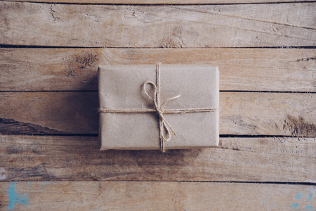 Above brown gift box on wooden table background with copy space.の写真素材