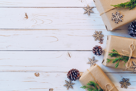 Homemade wrapped christmas gift box presents on a wood table background.の写真素材