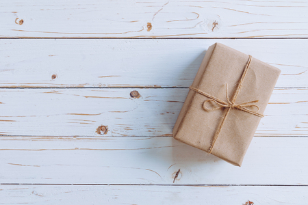 Above brown gift box on wooden table background with copy space.の写真素材
