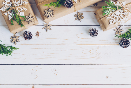 Homemade wrapped christmas gift box presents on a wood table background.の写真素材
