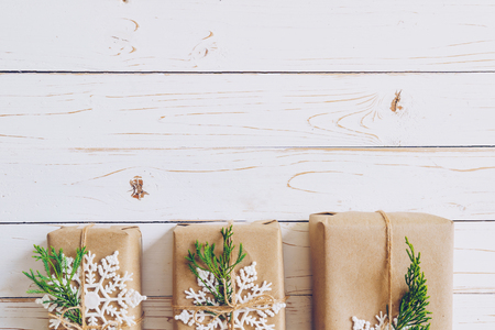 Homemade wrapped christmas gift box presents on a wood table background.の写真素材