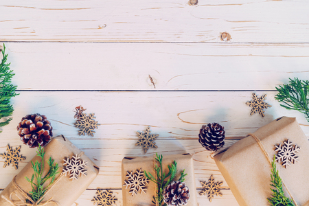 Homemade wrapped christmas gift box presents on a wood table background with space.の写真素材
