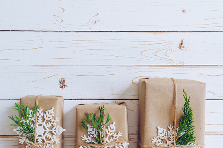 Homemade wrapped christmas gift box presents on a wood table background with space.の写真素材