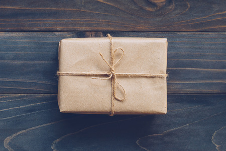 String or twine tied in a bow on paper gift box no wooden table texture and background.の写真素材