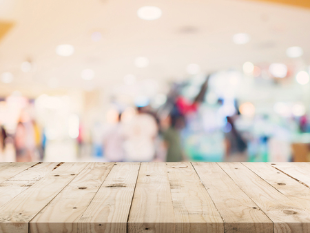 Empty wood table and blurred background image. supermarket blur background with space display montage for product.の写真素材