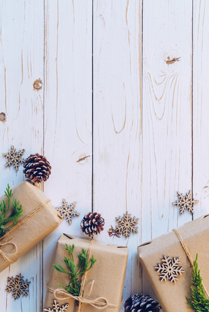 Homemade wrapped christmas gift box presents on a wood table background with space.の写真素材