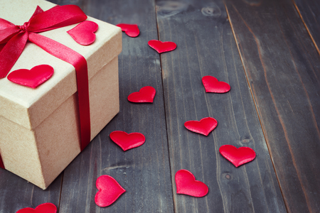 gift box and red heart on wooden table background with copy space.の写真素材