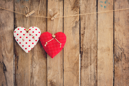 Heart  hanging on wood background with copy space.の写真素材