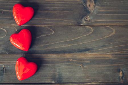 red heart on wood table background with copy spaceの写真素材