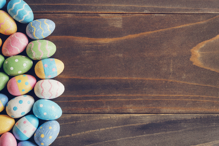 Top view of Easter eggs on rustic wood background with copy spaceの写真素材