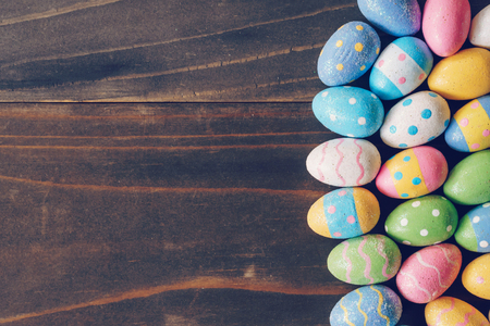 Top view of Easter eggs on rustic wood background with copy spaceの写真素材