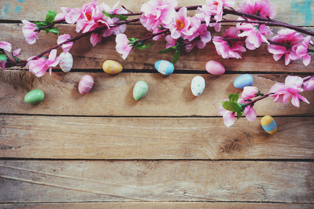 Cherry blossom Artificial flowers and easter egg on vintage wooden background with copy space.の写真素材